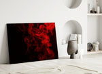 Red Smoke glass wall art styled above a sofa in a dark-walled lounge
