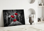 Red Umbrellas glass wall art styled above a sofa in a literary living room