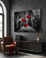 Red Umbrellas glass wall art displayed above a console in a designer interior