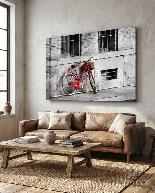 Red Bicycle glass wall art displayed above a console in a designer interior