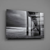 Close-up detail of concrete pillars vanishing into long-exposure water
