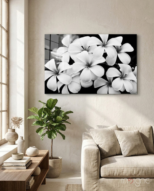 Flower plumeria glass wall art displayed above a console in a designer interior