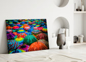 Colorful Umbrellas glass wall art styled above a sofa in a playful living room