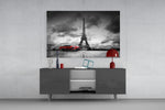Fine art photography – elegant red vintage automobile parked in front of towering Eiffel Tower, monochrome scene with selective crimson color