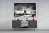 Fine art photography – elegant red vintage automobile parked in front of towering Eiffel Tower, monochrome scene with selective crimson color