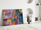 Abstract glass wall art styled above a sofa in a creative living room