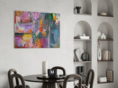 Abstract glass print enhancing a dining corner with painterly warmth