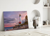 Lighthouse glass wall art styled above a bed in a coastal-inspired bedroom