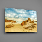 Close-up detail of golden boulders and turquoise surf on the beach