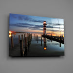 Close-up detail of the striped lighthouse reflected in still water