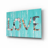 Love glass wall art displayed above a console in a designer interior