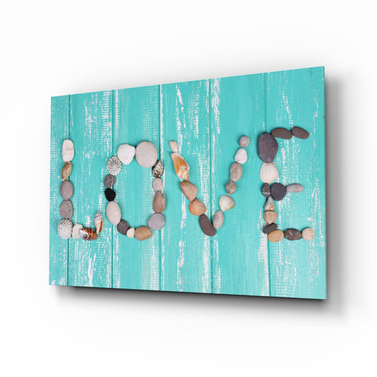 Love glass wall art displayed above a console in a designer interior