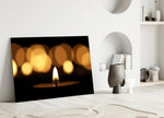 Close-up detail of the single flame with warm gold bokeh