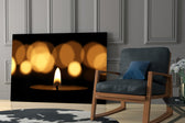 Candle glass print anchoring a bar with low-light warmth