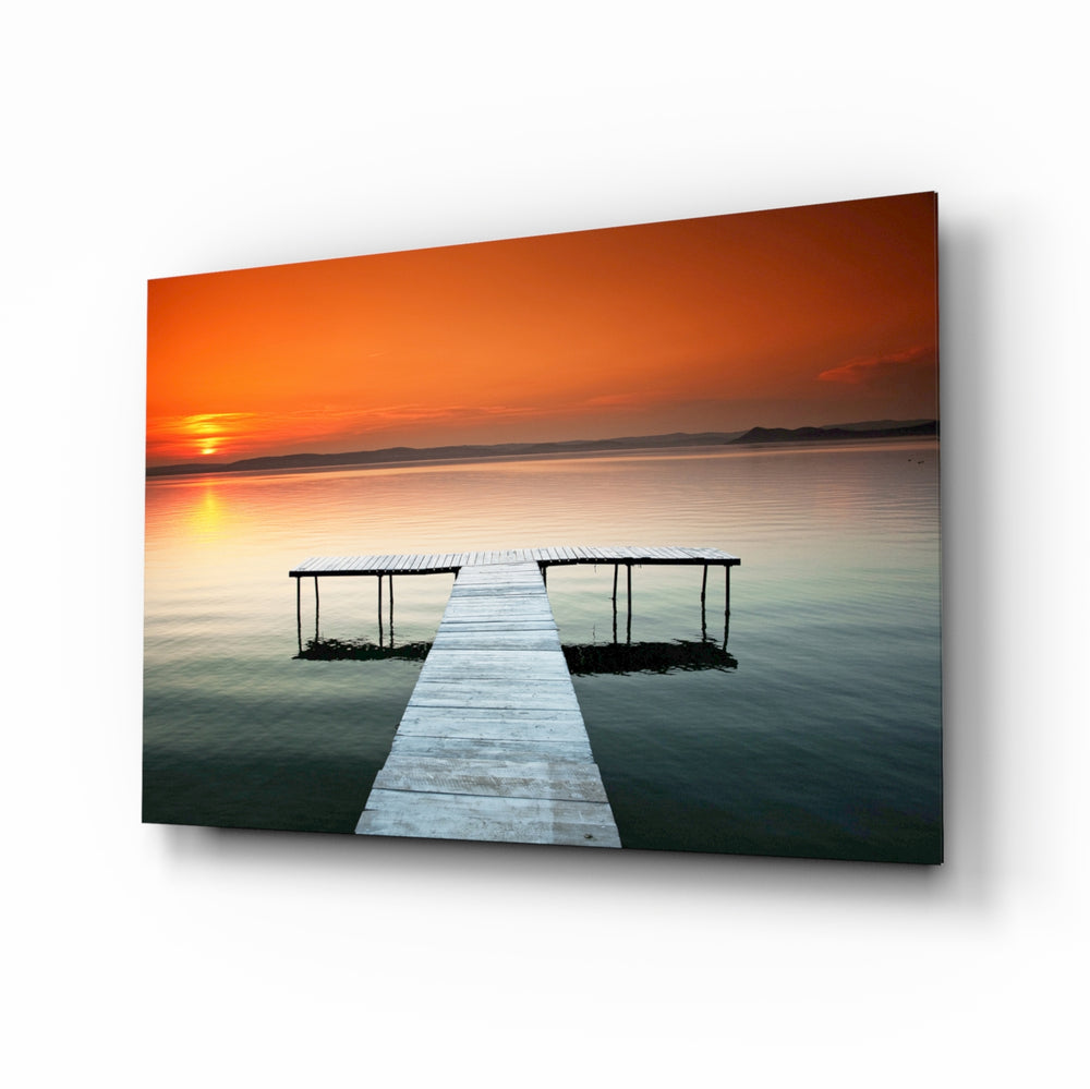 Dock orange sunset glass wall art displayed above a console in a designer interior