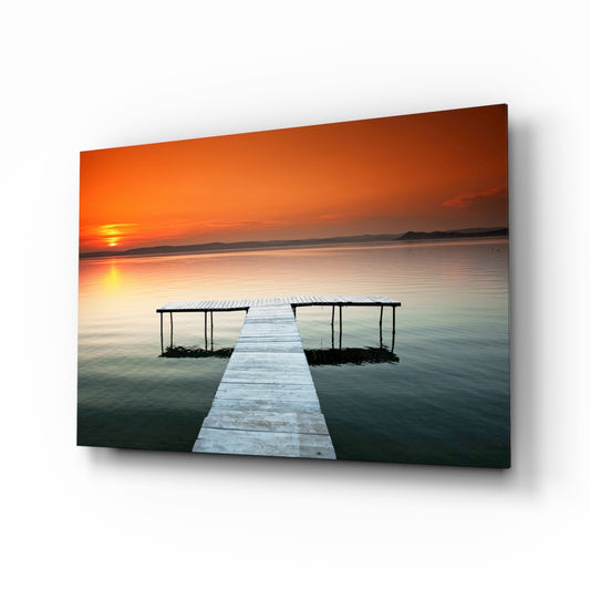 Dock orange sunset glass wall art displayed above a console in a designer interior