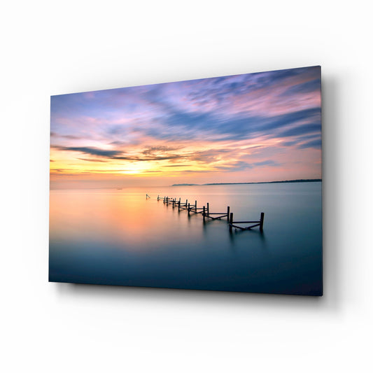 Sunset pier glass wall art displayed above a console in a designer interior