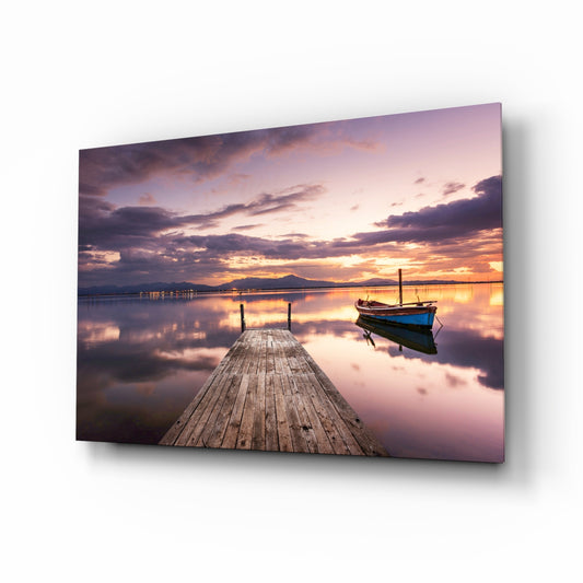 Dock twilight boat glass wall art displayed above a console in a designer interior