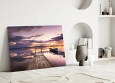Close-up detail of the rowboat at the dock under rose-lavender sunset