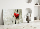 Close-up detail of the red ceramic heart on wood grain