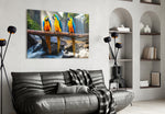 Parrots glass wall art styled above a sofa in a jungle-mood living room