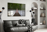 Suspension Bridge glass wall art styled above a sofa in a forest-mood living room