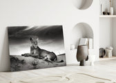 Close-up detail of the lioness's gaze against dramatic cloud sky