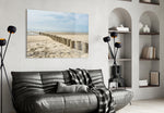 Beach glass wall art styled above a bed in a seaside retreat bedroom