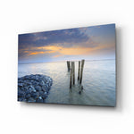 Sunset glass wall art displayed above a console in a designer interior