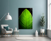 Green Leaf glass wall art styled above a bed in a biophilic bedroom