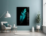 Green Feather glass wall art styled above a bed in a coastal-palette bedroom