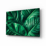 Green Tropical Leaf glass wall art displayed above a console in a designer interior