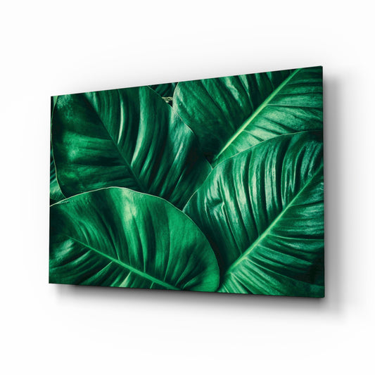 Green Tropical Leaf glass wall art displayed above a console in a designer interior