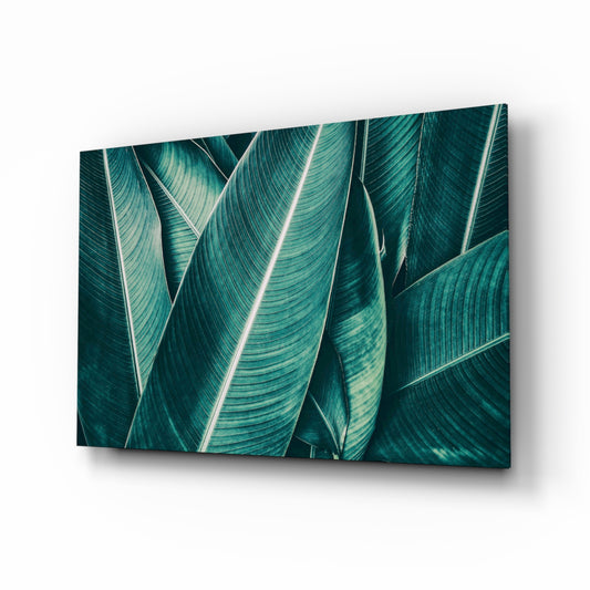 Green Tropical Leaf 2 glass wall art displayed above a console in a designer interior