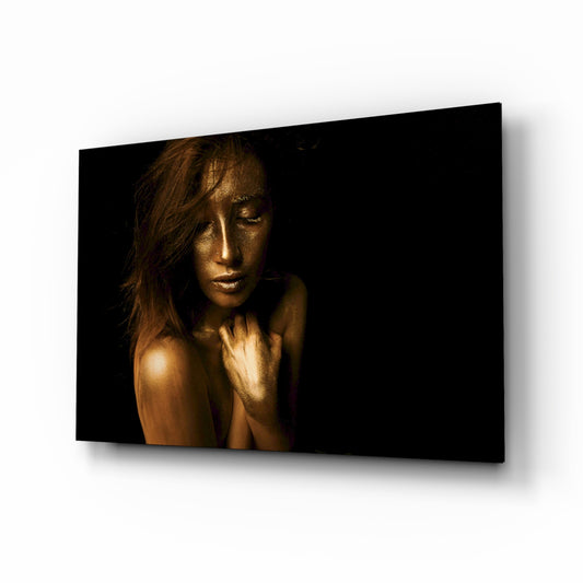 Woman glass wall art displayed above a console in a designer interior