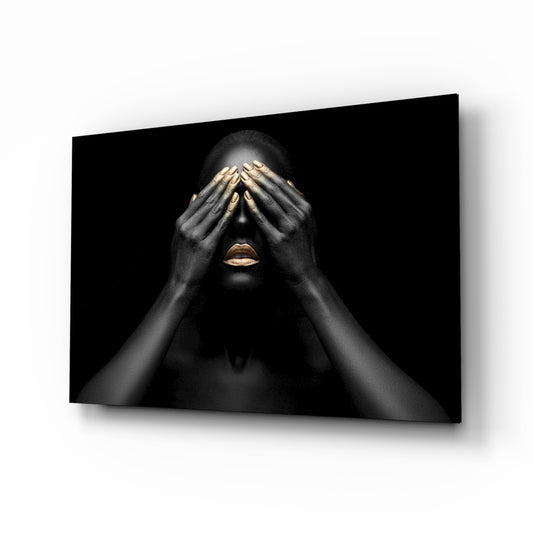 Woman glass wall art displayed above a console in a designer interior
