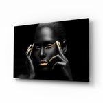Woman glass wall art displayed above a console in a designer interior