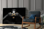 Woman glass wall art styled above a bed in an introspective bedroom