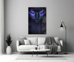 Woman glass wall art styled above a bed in a moody-color bedroom