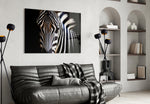 Zebra glass wall art styled above a sofa in a safari-mood living room