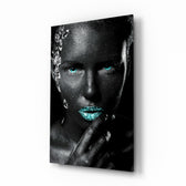 Woman glass wall art displayed above a console in a designer interior