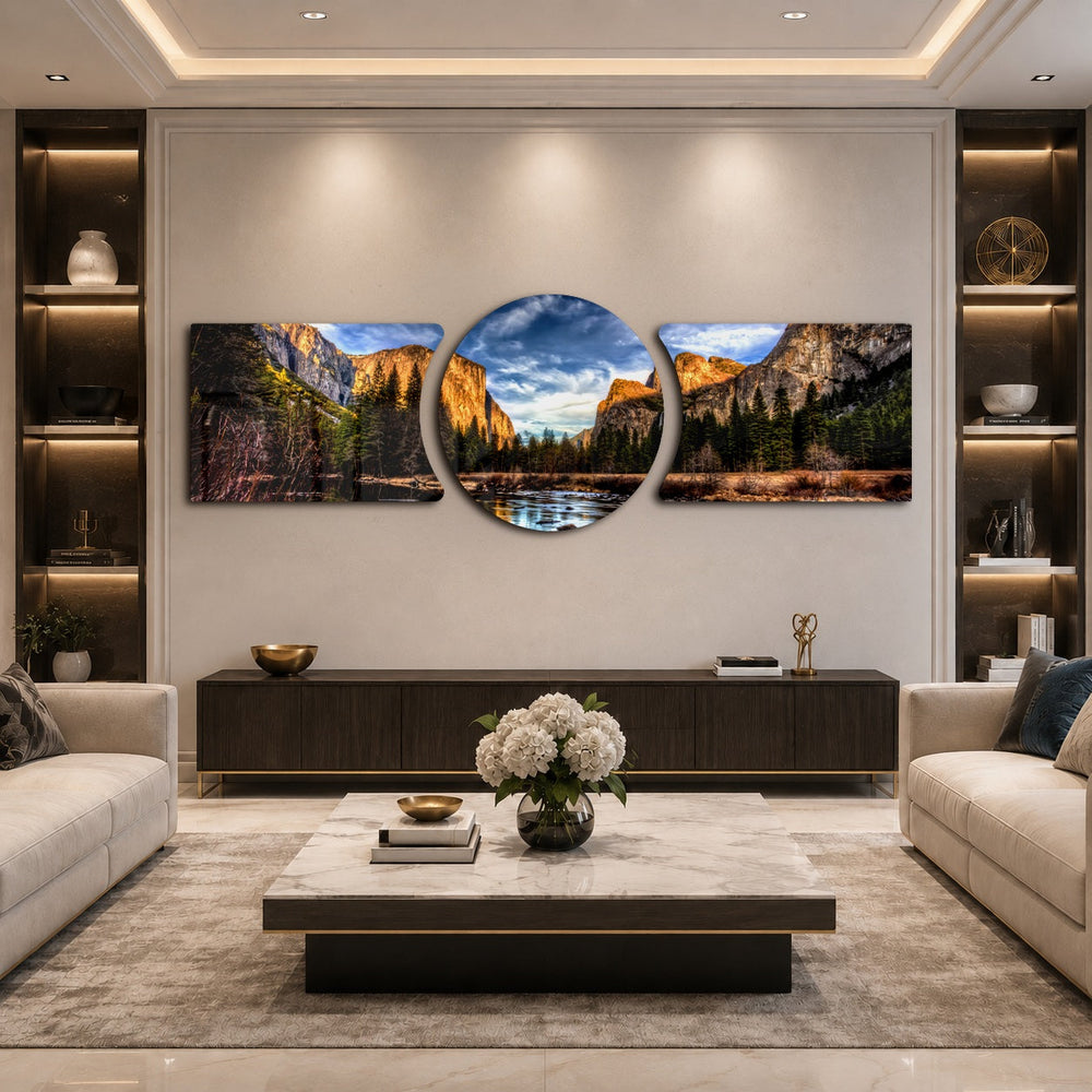 A panoramic mountain valley with golden-lit granite cliffs, a winding river, and a dense pine forest under a dramatic blue sky. 3 piece glass wall art set B