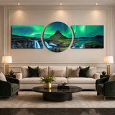 Green northern lights swirling over a peaked mountain, waterfall and calm fjord at night. 3 piece glass wall art set D