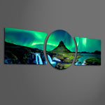 Green northern lights swirling over a peaked mountain, waterfall and calm fjord at night. 3 piece glass wall art set F