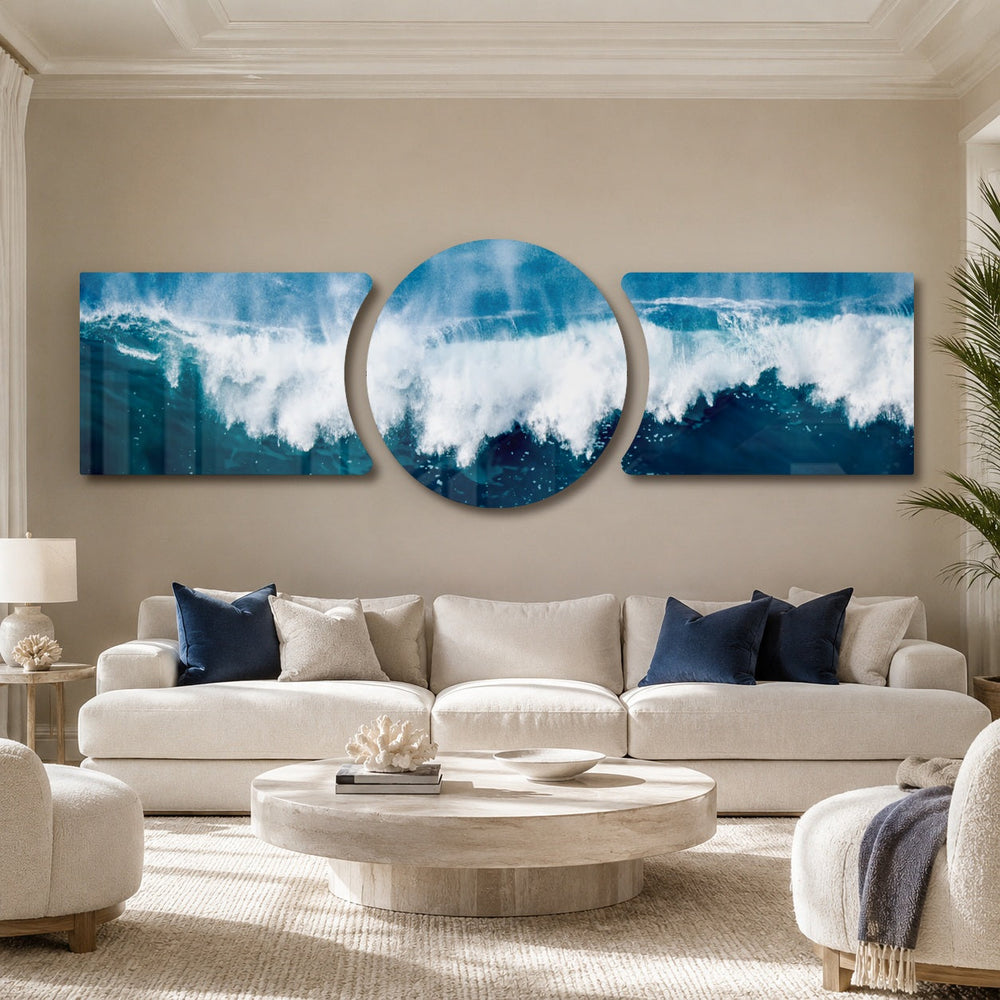A powerful ocean wave breaking into white foam and spray across deep blue and teal water under a soft sky 3 piece glass wall art set B