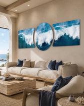 A powerful ocean wave breaking into white foam and spray across deep blue and teal water under a soft sky 3 piece glass wall art set C