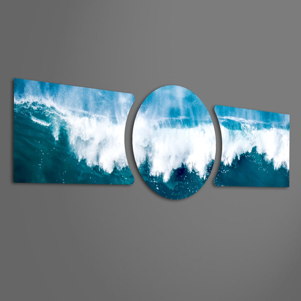 A powerful ocean wave breaking into white foam and spray across deep blue and teal water under a soft sky 3 piece glass wall art set F