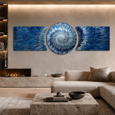 An abstract 3D starburst of blue and silver shards radiating outward from a bright glowing white center. 3 piece glass wall art set B
