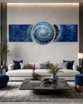 An abstract 3D starburst of blue and silver shards radiating outward from a bright glowing white center. 3 piece glass wall art set C