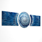 An abstract 3D starburst of blue and silver shards radiating outward from a bright glowing white center. 3 piece glass wall art set E